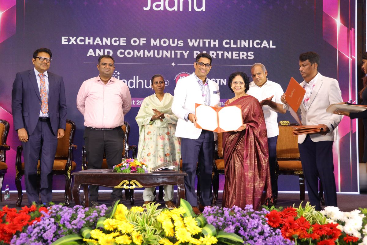 Signed Memorandum of Understanding between Jadhu and The Spastics Society of Tamil Nadu (SPASTN), Chennai, exchanged on stage in front of the Exchange of MOUs backdrop